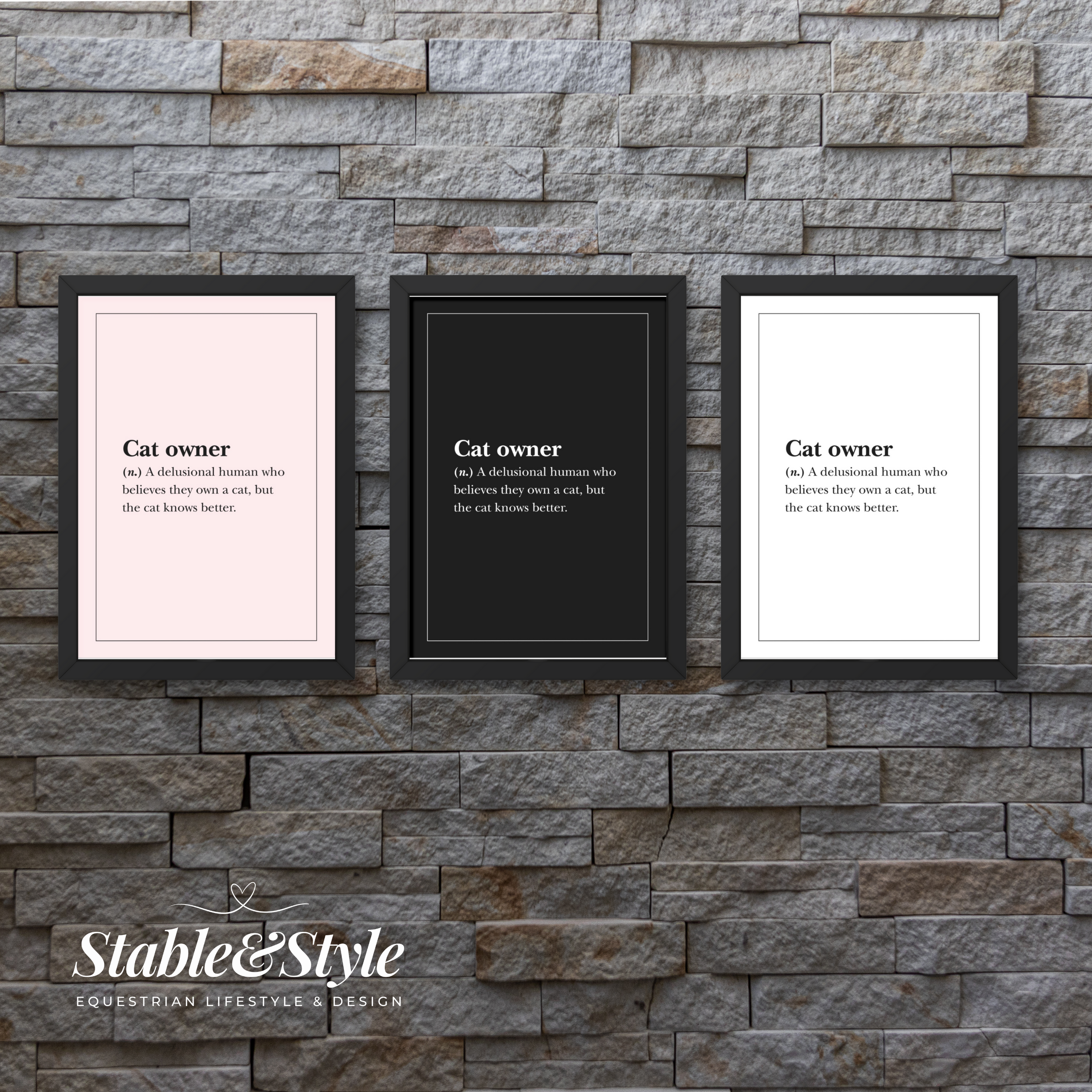 Three framed prints with definitions of 'cat owner' on a stone wall, featuring the brand 'Stable & Style'.