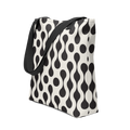 Tote bag with black strap and black and white pattern.