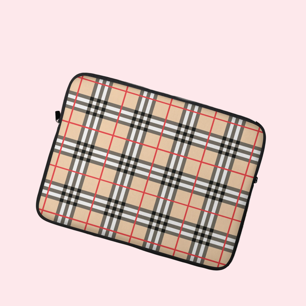 Plaid patterned laptop sleeve on a light surface