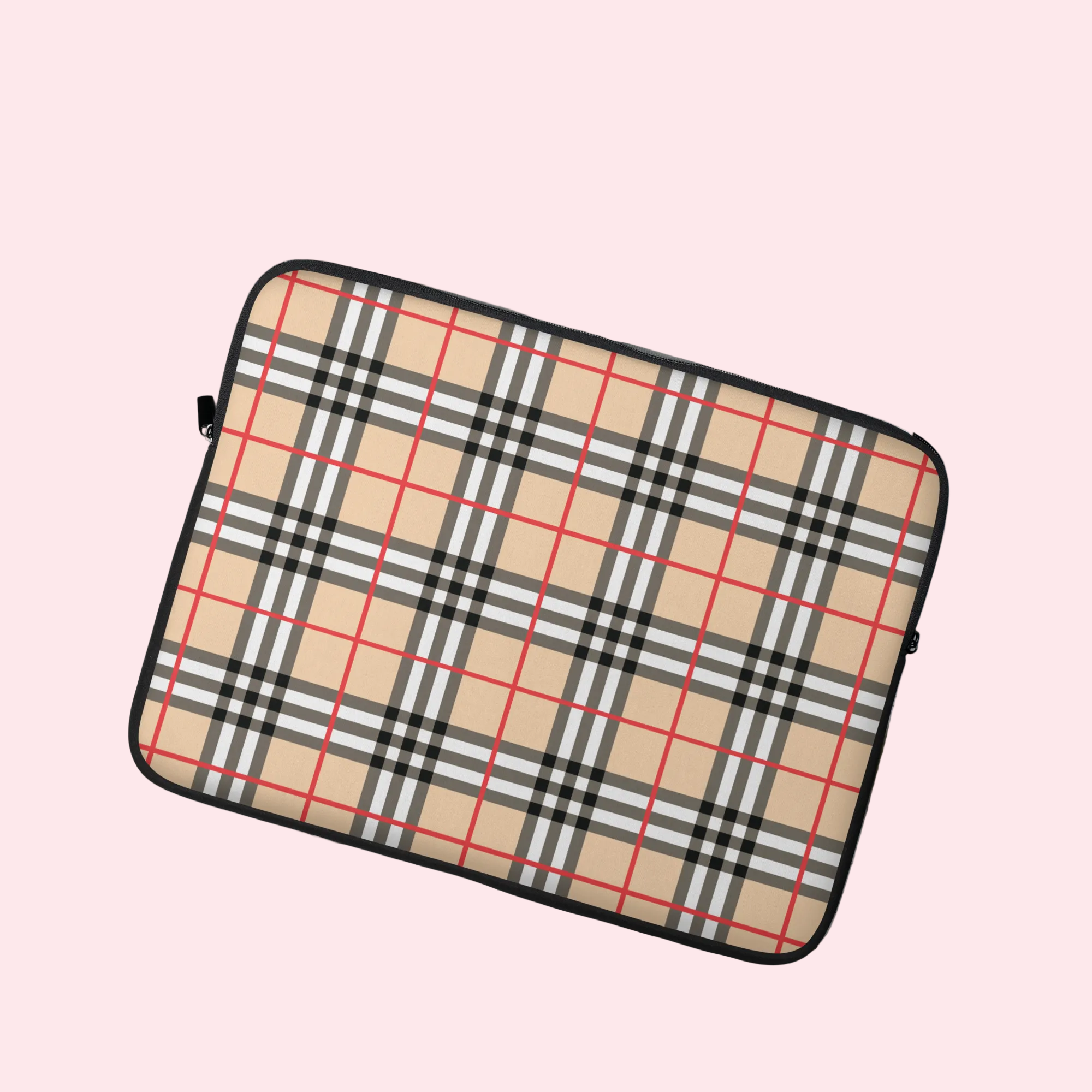 Plaid patterned laptop sleeve on a light surface