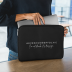 Woman holding a laptop in a black sleeve with text