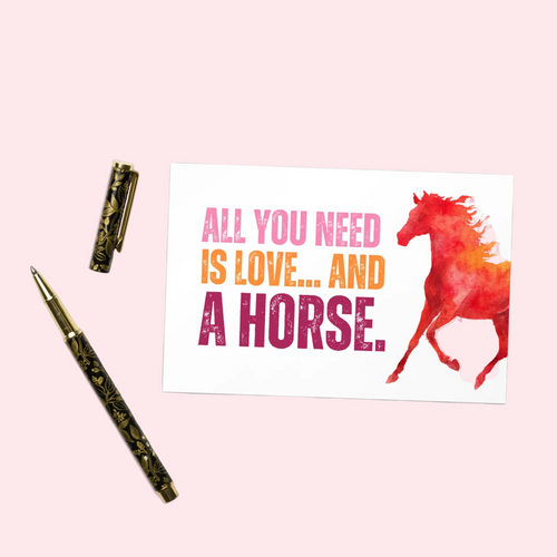Card with horse illustration and text 'All you need is love... and a horse' on a pink background, with a pen beside it.